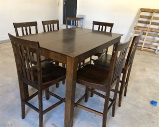 #24)  $200 - Solid Wood Counter Height Dining Table with 7 Barstool height Chairs.  36 x 54 x 36h.  Stools are 24 inches to the seat.  There are some scratches and marks on the seats and the table.