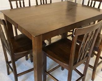 #24)  $200 - Solid Wood Counter Height Dining Table with 7 Barstool height Chairs.  36 x 54 x 36h.  Stools are 24 inches to the seat.  There are some scratches and marks on the seats and the table.