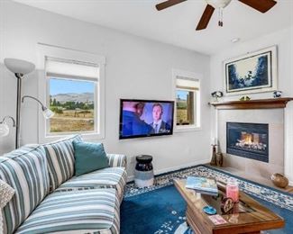 Open Living Room with Double Gas Fireplace. Access to Nice Deck with wonderful views. 