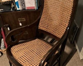 Antique rocker with cane seat and back