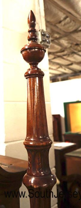 Lot 564
Traditional mahogany banded four poster carved queen size bed with rails