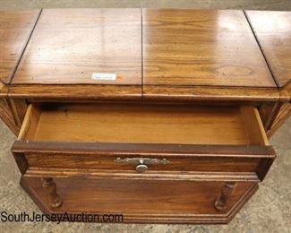 Lot 570
Thomasville Furniture country oak flip top server