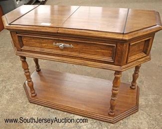 Lot 570
Thomasville Furniture country oak flip top server