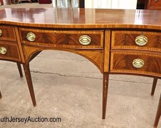 Lot 589
Councill Furniture mahogany banded and bell flower inlaid tamper leg sideboard