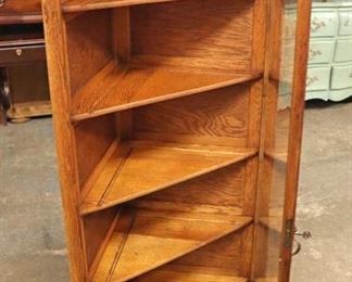 Lot 600
ANTIQUE oak corner cabinet with brass pineapple finials in the original finish with key