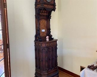 Antique and very unusual German clock.  Too tall in this home to have the crown piece on the top.  it is shown in the next photo.  The clock measures 15” d x 24”w x 104” h   More photos follow.  $1800