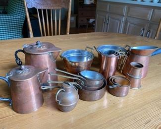 Collection of copper articles including: 2 miniature colanders, small pots, 3 setoff measuring cups, etc. height of largest piece 4 1/2"h                                   