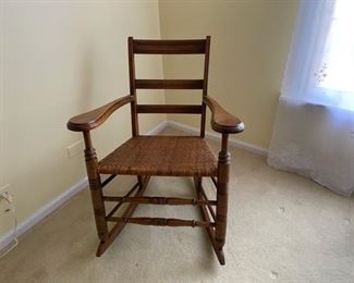 Antique rocking chair with woven seat                     125.00                                 