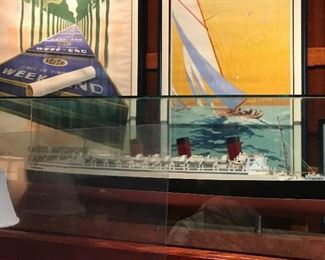 RHS Queen Mary ship model by Alan Raven. This museum quality ship model was displayed behind main bar at Clyde's restaurant in Columbia, MD for thirty years.

Crotch Mahogany casing veneer over Pine. Brass supports for Boat. Satinwood urn inlay.

Base depth 18". Length 75".
On 5" base. Overall height 27.5"

Sold to Clyde's in 1989 by San Francisco Ship Model Gallery for $25,000.

Some minor deck top damage to the detail rigging in need of repair.

