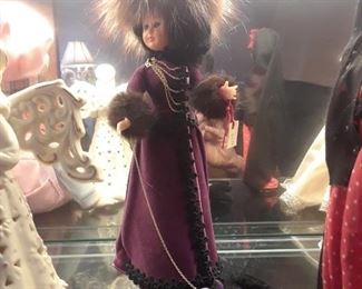 Elegantly outfitted doll with elaborate fur accents on her coat