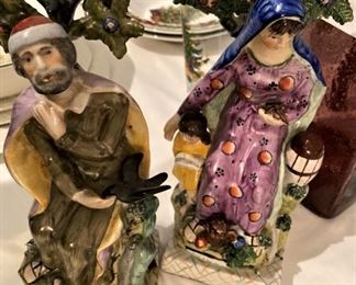 Antique pair Staffordshire table base figures of "Elijah and the Widow." Both figures modeled sitting on a naturalistic base in front of bocage. (Holy Bible - 1 Kings 17:7-16)