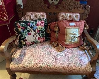 Antique settee; some of the many needlepoint pillows