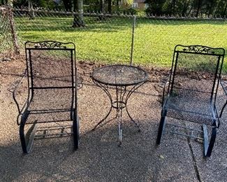 cantilever wrought iron pair of chairs and separate table