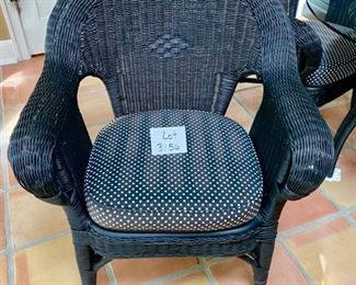 Lot 3156. $395.00. Vintage Black Wicker Round Table With Glass Top and 4 Chairs with cushions. Has hole for an umbrella, however, this was described to us as an indoor wicker set.  Still, an umbrella would look cute even indoors!    Cushions are Polkadot and in good shape.  