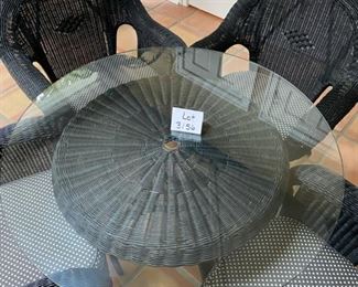 Lot 3156. $395.00. Vintage Black Wicker Round Table With Glass Top and 4 Chairs with cushions. Has hole for an umbrella, however, this was described to us as an indoor wicker set.  Still, an umbrella would look cute even indoors!    Cushions are Polkadot and in good shape.  