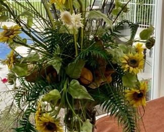 Lot 3158. $200.00. Becket Water Gardening Statue Fountain with 3 Cherubs, made of resin, filled with faux floral, shown as a planter featuring sunflowers, lemons, and greenery.  22" Tall x 16" Round  - we didn't attempt to measure the floral display, nor did we try out the fountain but owner claims it works. Cool!   