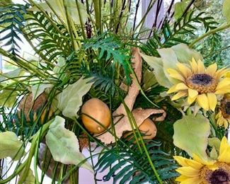 Lot 3158. $200.00. Becket Water Gardening Statue Fountain with 3 Cherubs, made of resin, filled with faux floral, shown as a planter featuring sunflowers, lemons, and greenery.  22" Tall x 16" Round  - we didn't attempt to measure the floral display.   