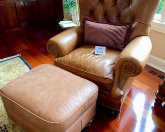Lot 3182. $525.00  1 of 2 Classic Leather Chair and Ottoman with nailhead trim detail. Was $1950 new! Medium Brown	chair: 40"H to back x 29"D x 39"W  Seat: 19"H x 20"W x 22"D;  Ottoman: 22"w x 21"x 17"H	Note that the ottoman is quite faded and worn, however, there is a product on the market that will restore this leather to its original luster.  Set looks better than what it looks like in this bright location.  