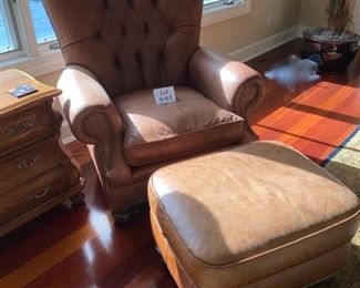 Lot 3183. $525.00  2 of 2  Classic Leather Chair and Ottoman with nailhead trim detail. Was $1950 new! Medium Brown	chair: 40"H to back x 29"D x 39"W  Seat: 19"H x 20"W x 22"D;  Ottoman: 22"w x 21"x 17"H	Note that the ottoman is quite faded and worn, however, there is a product on the market that will restore this leather to its original luster.  Set looks better than what it looks like in this bright location.  