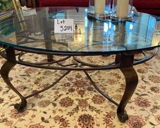 Lot 3204. $325.00 Gorgeous Oval Coffee Table with rounded beveled glass edge. gold-accented wrought iron base	49"W x 37"D x 19"H	  A good size, and we recommend this table, especially if you have a good looking rug underneath it.  Really opens up a room!