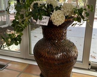 Lot 3164. $54.00  Large wicker urn with square wood base.  This lot includes the faux floral and greenery. 	29"H x 17"D	 