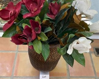 Lot 3165.  $35.00  Attractive wicker urn with florals.  The sides of this urn are slightly flattened so that it can be laid on its side for display as well.  25"H x 12"D	