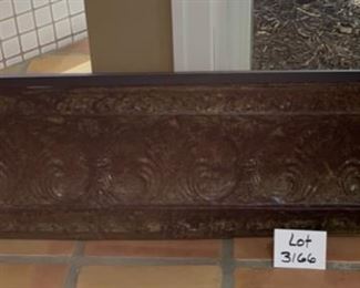 Lot 3166. $50.00  Distressed embossed tin-faced shelf.  Decor in relief on front of shelf.  Great accent piece.  49"w x 7.5"d x 13"t	