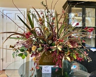 Lot 3216. $175.00  Unique Large Scale floral centerpiece in bronze colored  container with Faux flowers and exotic bird feathers. the base is 16'L x 8"W x 9" H,  Floral 48"W x 42"H		 
