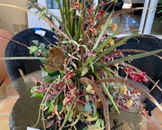 Lot 3216. $175.00  Unique Large Scale floral centerpiece in bronze colored  container with Faux flowers and exotic bird feathers. the base is 16'L x 8"W x 9" H,  Floral 48"W x 42"H	View from above.	 
