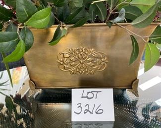 Lot 3216. $175.00  Unique Large Scale floral centerpiece in bronze colored  container with Faux flowers and exotic bird feathers. the base is 16'L x 8"W x 9" H,  Floral 48"W x 42"H	View of the Base	 