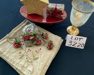 Lot 3220. $32.00  8 Crate and Barrel Gold napkins and 8 Crate and Barrel  holly napkin rings ; Melrose International Co. red pedestal plate (12.5" x 8' x 3.5" t); Gold star shaped box with potpourri and a Holiday star footed hurricane.		