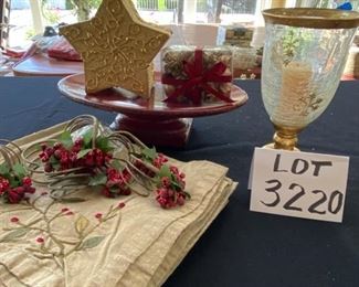 Lot 3220. $32.00  8 Crate and Barrel Gold napkins and 8 Crate and Barrel  holly napkin rings ; Melrose International Co. red pedestal plate (12.5" x 8' x 3.5" t); Gold star shaped box with potpourri and a Holiday star footed hurricane.		