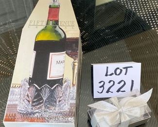 Lot 3221.  $24.00 Fifth Avenue Ltd Crystal "portico"     6 pc wine accessory set.  This lovely set is 24% lead crystal.  2 cute white snowball candles round off this fetive lot.		