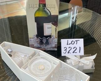 Lot 3221.  $24.00 Fifth Avenue Ltd Crystal "portico"     6 pc wine accessory set.  This lovely set is 24% lead crystal.  2 cute white snowball candles round off this fetive lot.		