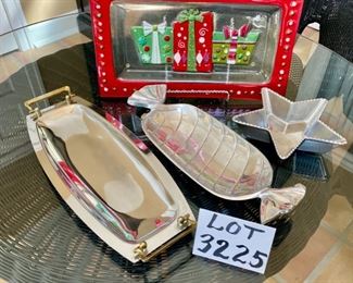 Lot 3225. $50.00.  A lovely assortment of mixed metal and glass holiday serving pieces, and very festive at that!  An 8" x 8" star dish by ARTHUR COURT; Lori Sievert for Silvestri hand blown rectangular Christmas plate (15" x 8.5"); so mod 17" x 7" Kromex silver tray and a cute 15" x 5.5" candy dish shaped like wrapped hard candy.  		