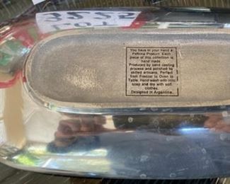 Lot 3225. $50.00.  A lovely assortment of mixed metal and glass holiday serving pieces, and very festive at that!  An 8" x 8" star dish by ARTHUR COURT; Lori Sievert for Silvestri hand blown rectangular Christmas plate (15" x 8.5"); so mod 17" x 7" Kromex silver tray and a cute 15" x 5.5" candy dish shaped like wrapped hard candy.  		