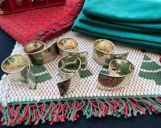Lot 3226.  $50.00  24 Red, Green and Plaid Christmas Napkins (mostly from Crate and Barrel); 2 table runners (14x36 & 13 x 56); 1 square tablecloth (60x60) and 10 napkin holders.  You can't have too many!  	