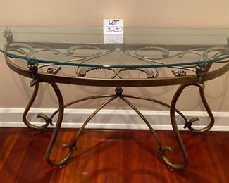 Lot 3230.  $295.00   Fabulous glass half-moon, or "Demi Lune" table with wrought iron artfully swirled on the base under the glass top.  This is a substantial table, 52"W x 18"D x 29" H.   Perfect for a foyer, or behind a sofa, or holding a lamp.  
