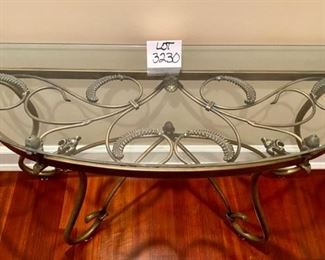 Lot 3230.  $295.00   Fabulous glass half-moon, or "Demi Lune" table with wrought iron artfully swirled on the base under the glass top.  This is a substantial table, 52"W x 18"D x 29" H.   Perfect for a foyer, or behind a sofa, or holding a lamp.  