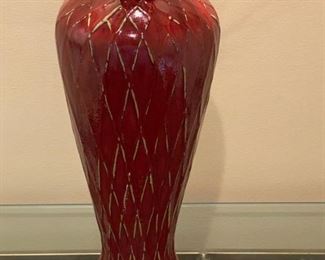 Lot 3231. $38.00  Ceramic vase with reddish glaze and burnt red twigs, triangle design in relief.  Very striking.  I love this piece, how dramatic it looks under that spotlight!  