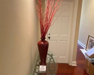 Lot 3231. $38.00  Ceramic vase with reddish glaze and burnt red twigs, triangle design in relief.  Very striking.  I love this piece, how dramatic it looks under that spotlight!  