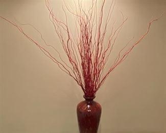 Lot 3231. $38.00  Ceramic vase with reddish glaze and burnt red twigs, triangle design in relief.  Very striking.  I love this piece, how dramatic it looks under that spotlight!  