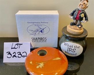 Lot 3232.  $24.00 Two cute pieces make up this lot. 1)Georgetown Pottery vase Ikebana-style, with a nifty flower frog.  and a sweet figurine holding out his pocket "What the IRS missed",  a cork-topped money jar.  