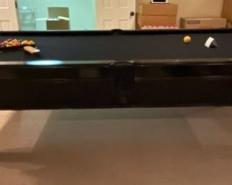 Lot 3271A. $975.00  AMF Play Master 8' regulation, slate top pool table.  This is a sleek black wood frame table with leather pockets and a dramatic black felt top.  This lot includes 6 cues, 1 bridge, 1 set of billiard balls and table accessories. In great condition.  Ask us about the Pool Table Service, we use to deliver and assemble this pool table. This item will need to be professionally moved! 