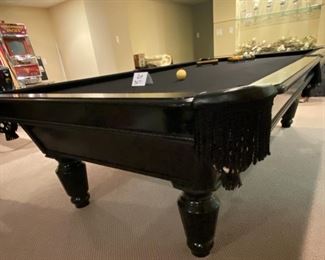 Lot 3271A. $975.00  AMF Play Master 8' regulation, slate top pool table.  This is a sleek black wood frame table with leather pockets and dramatic black felt top.  This lot includes 6 cues, 1 bridge, 1 set of billiard balls and table accessories. In great condition.  Ask us about the Pool Table Service, we use to deliver and assemble this pool table. This item will need to be professionally moved! 