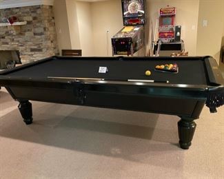 Lot 3271A. $975.00  AMF Play Master 8' regulation, slate top pool table.  This is a sleek black wood frame table with leather pockets and dramatic black felt top.  This lot includes 6 cues, 1 bridge, 1 set of billiard balls and table accessories. In great condition.  Ask us about the Pool Table Service, we use to deliver and assemble this pool table. This item will need to be professionally moved! 