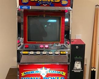 Lot 3273. $250.00  American Classics Draw Poker Slot Machine by SMK Corp 1991 that is Casino quality.   This slot machine comes with keys and a dollar bill changer.  The machine does turn on, lights up and appears to operate but the CRT Screen does not work and repairable.