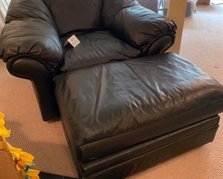 Lot 3275  $425.00. Black leather chair and ottoman.  This set is in good condition, clean and nice quality leather (not bonded).  Chair: 48"W  x  32"H x 36"D; Ottoman: 36"W x 22"D x 18" H	
