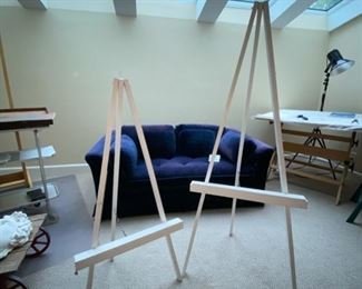 Lot 3276. $150.00 Navy Blue, velveteen, single seat cushion love seat.  This piece is slightly faded but would be great with a slipcover or Afghan.  Perfect for a small bedroom or living area.  Easels are Lot 3357.