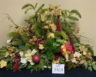 Lot 3303.  $175.00  Gorgeous Christmas Floral Arrangement, custom - made.  Top of the line florals and ornaments. This piece would work well on a mantle or down the middle of a table. 42"W x 22"H   Just beautiful!